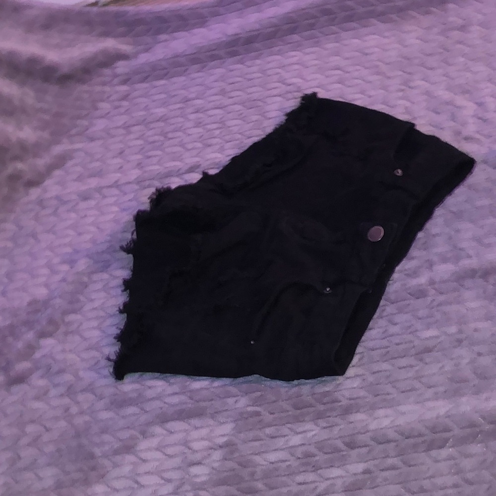 black jean shorts with rips in them